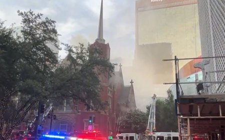 Smoke rises above the historic First Baptist Church in downtown Dallas