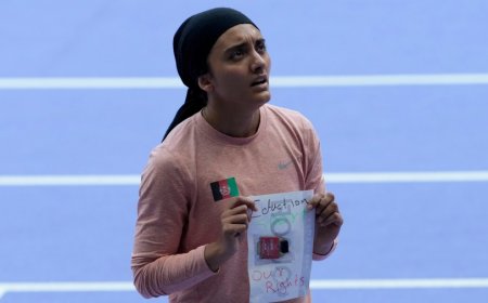 Afghan Olympic runner competes with message to the Taliban on her bib