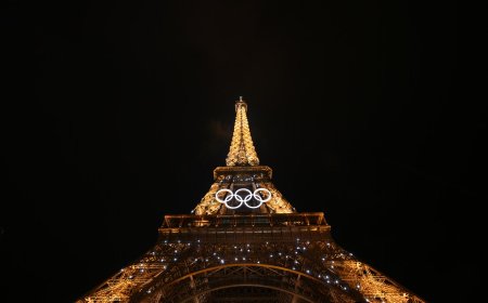 Eiffel Tower evacuated after man climbs up to Olympic rings